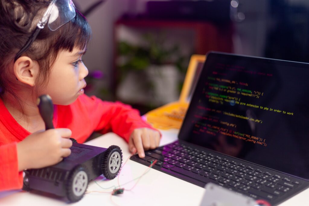 Asia students learn at home in coding robot cars and electronic board cables in STEM,