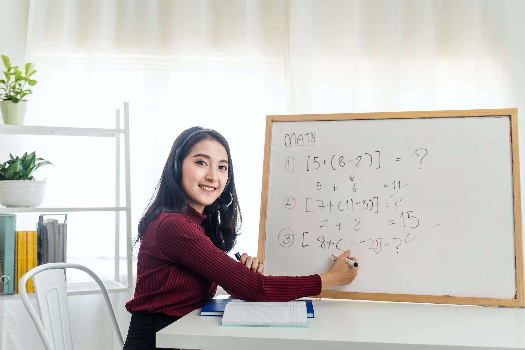 Asian school young woman teacher working from home teach online math subject to student.