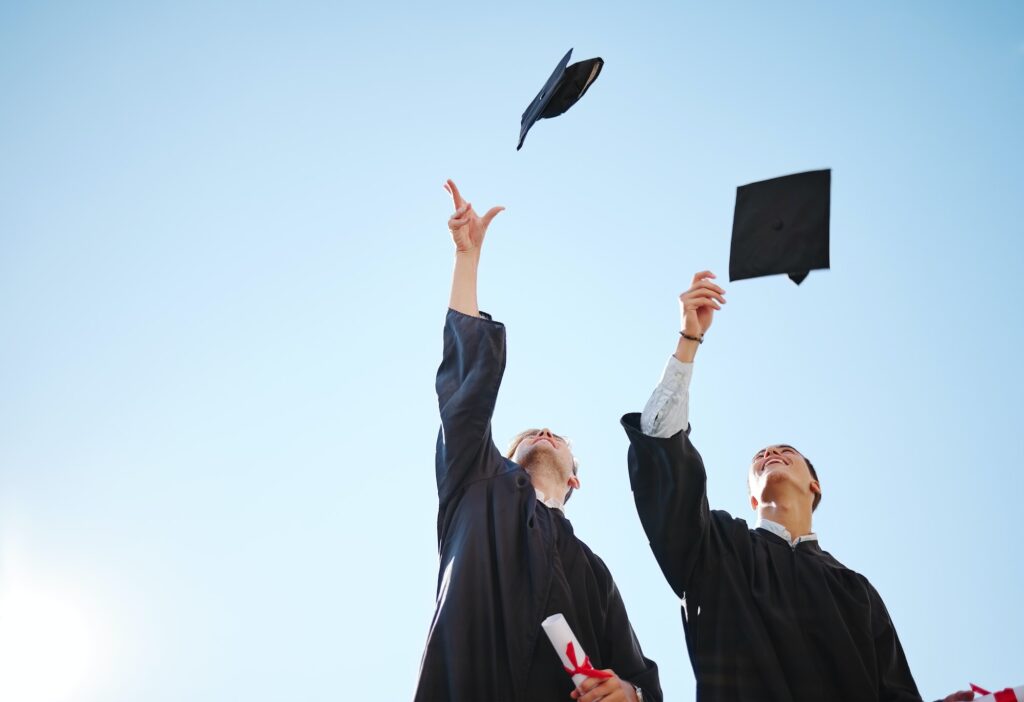 Graduation cap throw, blue sky and friends after a diploma, certificate and degree ceremony event.