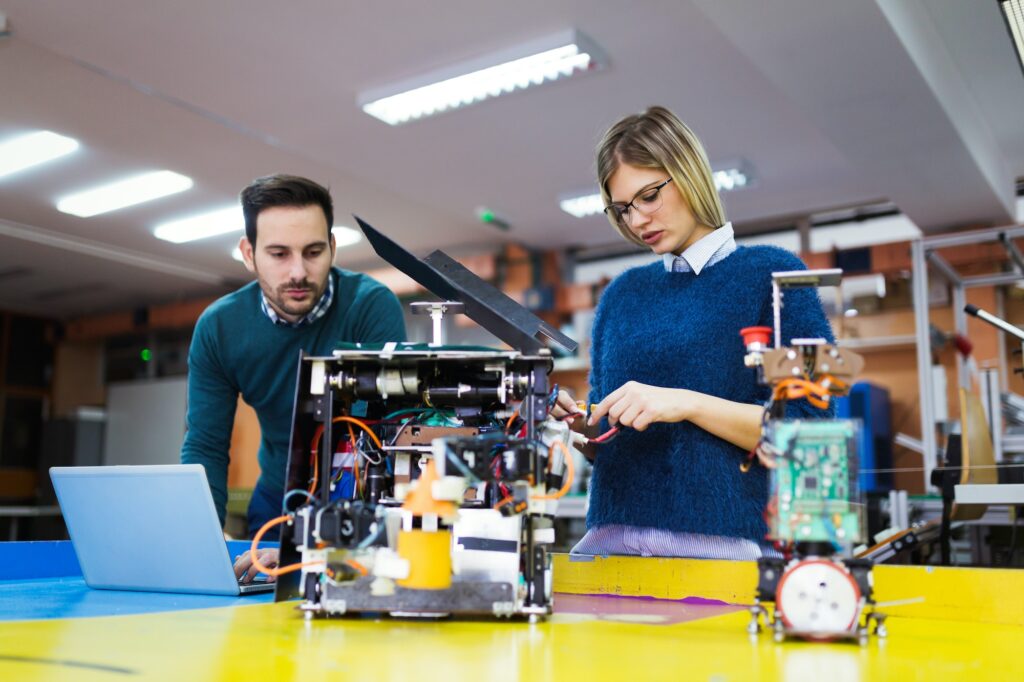 Young students of robotics working on project